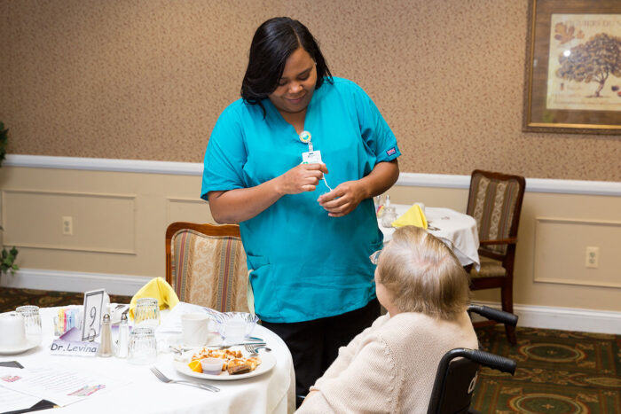 senior living caregiver talking with a resident