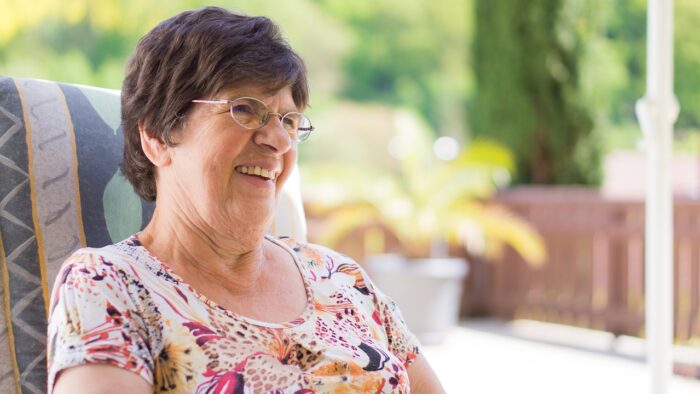 senior living community resident relaxing outside