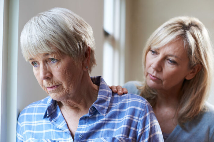 caregiver consoling a woman