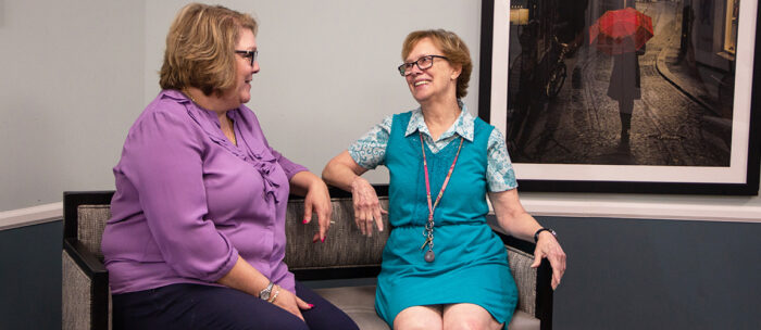 assisted living resident talking with a independence village team member