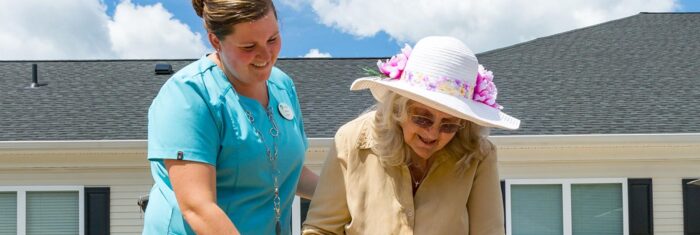 senior woman and staff member outside