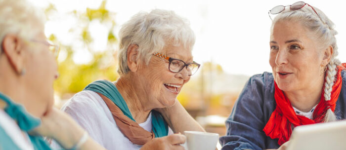 seniors enjoying the warm weather by having tea outside