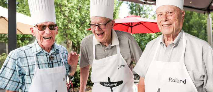 seniors outside barbecuing together