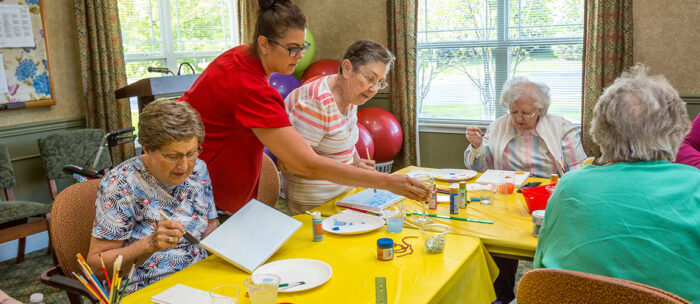 senior living residents painting at a community event