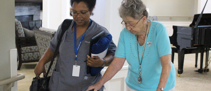 StoryPoint health care team member assisting a resident to her senior living apartment