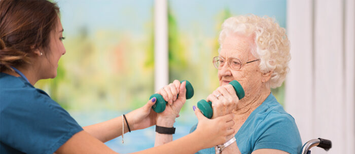 senior women practicing low impact exercises for seniors with a medical assistant