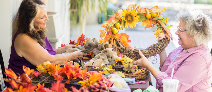 two seniors making fall crafts