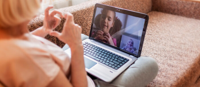 grandma using a video chat device to video call her grand daughter
