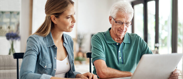 father and daughter looking at senior living moving tips and discussing