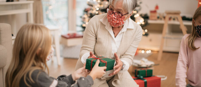 woman giving a gift to her grandchild