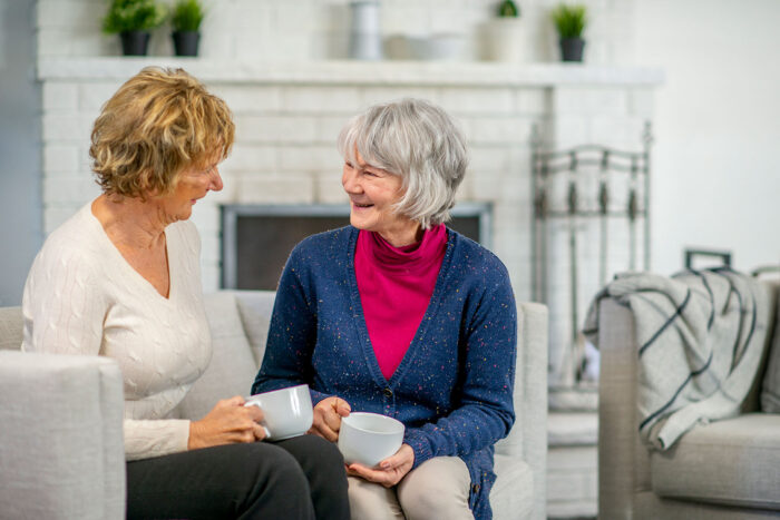 Mother and daughter having tea together