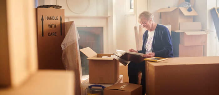 Senior woman packing and preparing to move