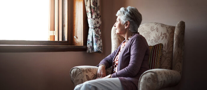 Senior looking out window