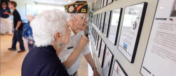 Independence Village residents looking at the veterans wall of honor