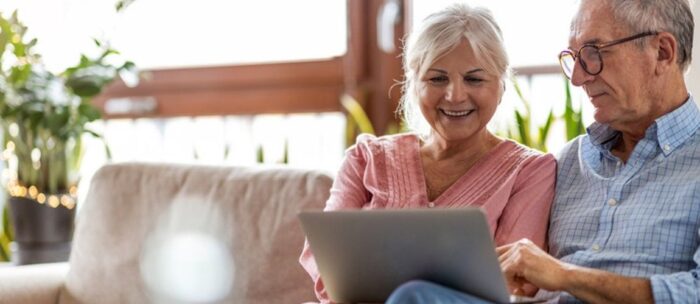 Senior couple looking at communities online