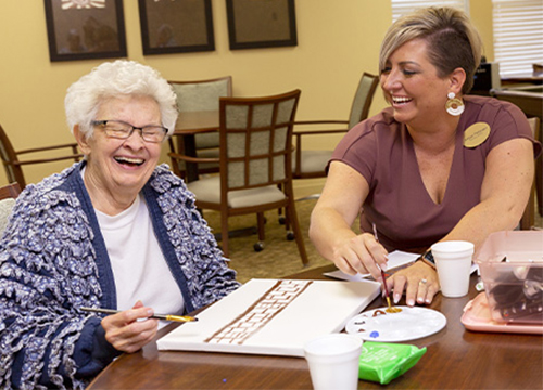 StoryPoint senior woman smiling painting