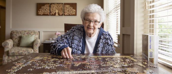 Senior woman doing a jigsaw puzzle at Independence Village