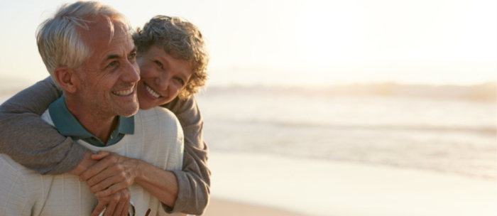 senior couple walking beach