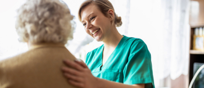 caregiver comforting senior woman