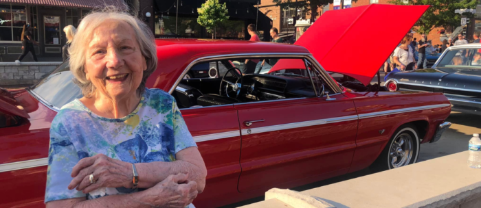 senior woman outside in car show