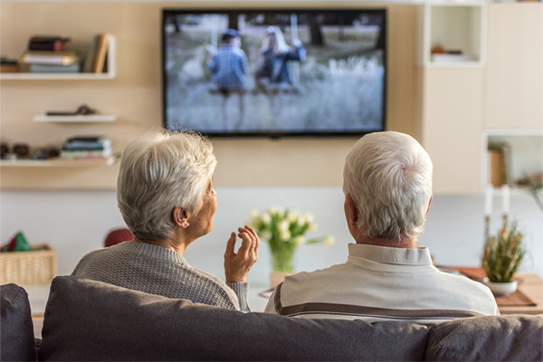 senior couple watching tv