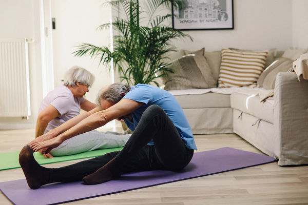 man touching toes yoga