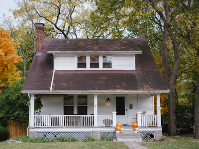 old house with pumpkins outside