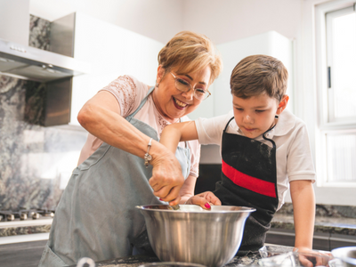 senior woman baking with grandson