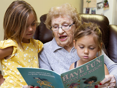 woman reading to grandchildren