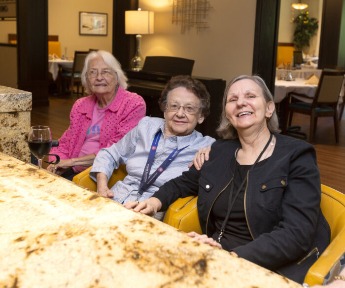 three older women sitting at bar