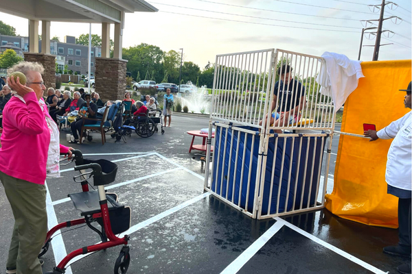 A senior woman at a dunk tank