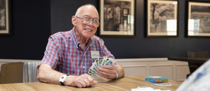 senior man playing cards