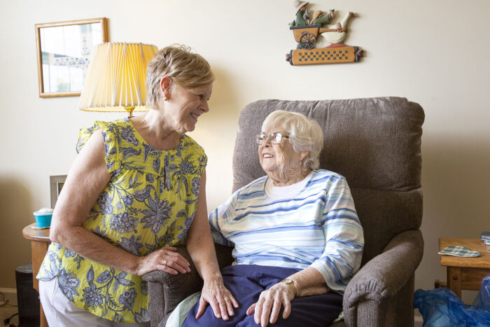 woman helping elderly mother