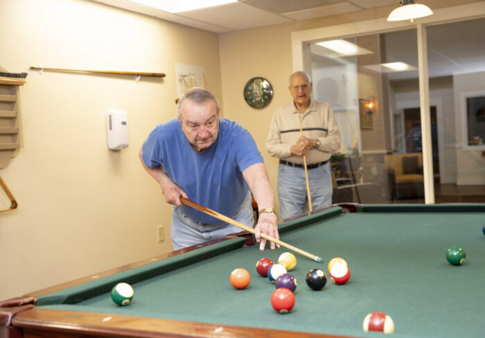 elderly man playing pool