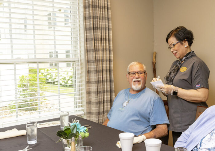 senior man giving food order to server