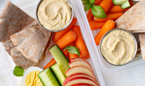 Healthy and nutricious lunch or snack boxes to go with hummus and pita, eggs and vegetables