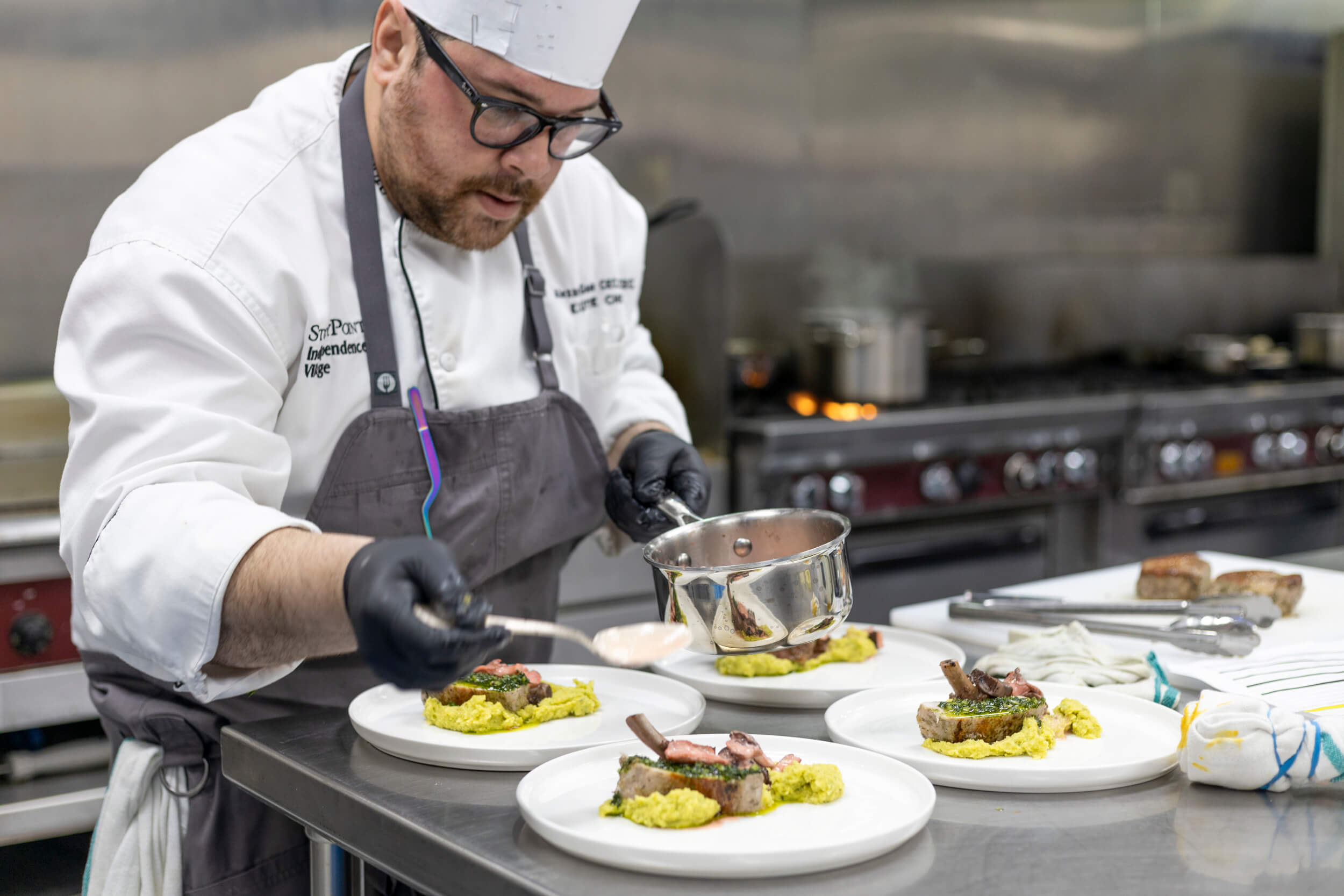 StoryPoint Chef saucing food at the 2023 Dorsey Culinary Competition