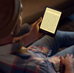 person using an Amazon Kindle Paperwhite e-Reader