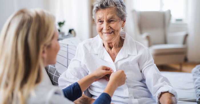 skilled nursing caregiver helping resident