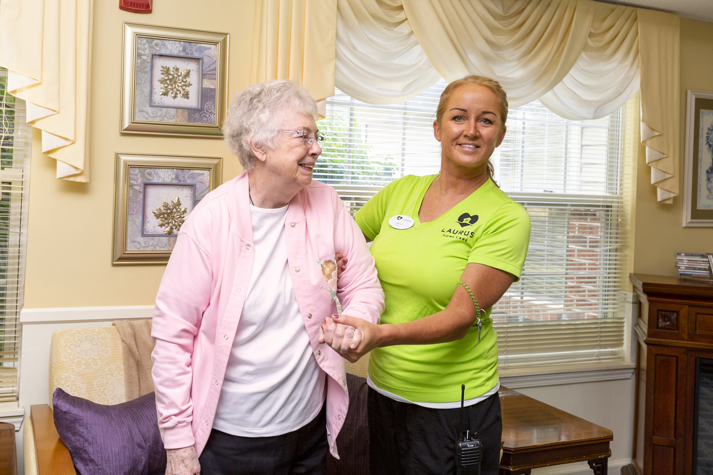 Caregiver helping resident stand up 