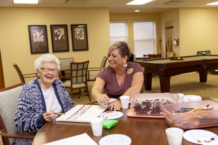 StoryPoint resident painting with an employee