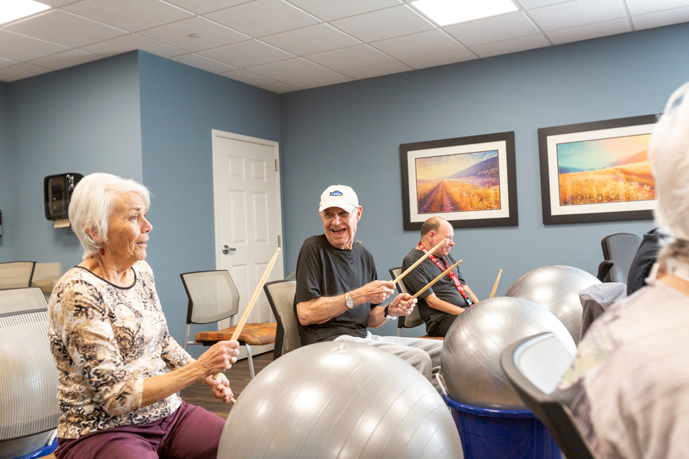 senior living residents drumming activity