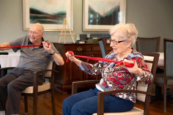 senior living residents working out with bands