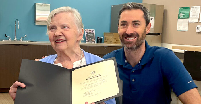 avon Lake Resident holding recognition and smiling