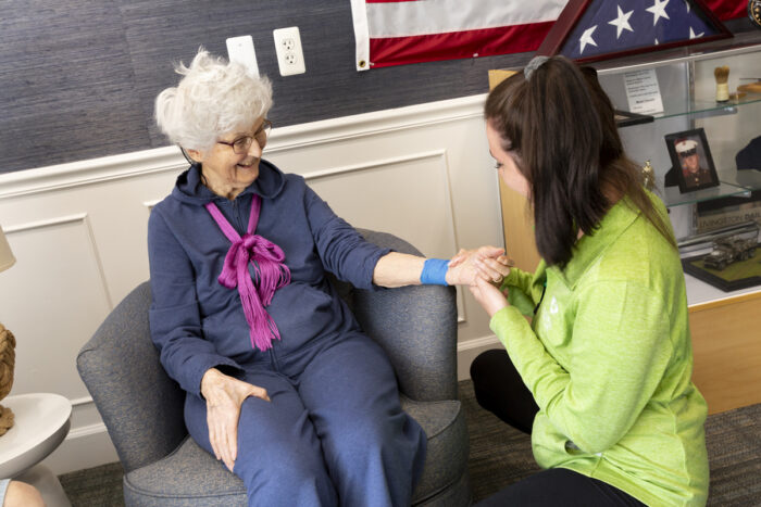 caregiver checking resident pulse
