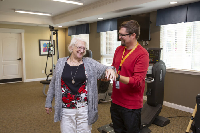 caregiver helping woman with therapy