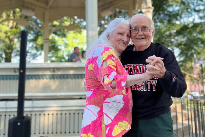 couple of seniors holding hands and hugging