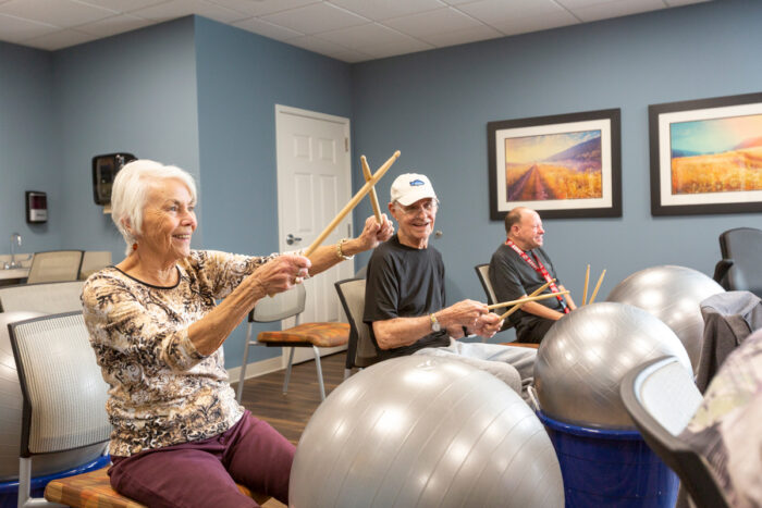 group of seniors with drumsticks and gym balls