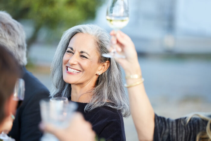 senior woman smiling and toasting