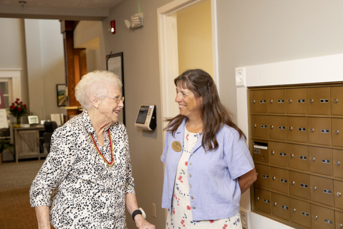 StoryPoint resident and caregiver smiling to each other